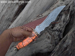 Rain drop Damascus Knife with turquoise stone handle in an outdoor setting, perfect for camping and hunting adventures.