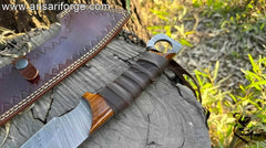 Leather-wrapped rosewood handle on survival machete - ergonomic grip for heavy-duty use.