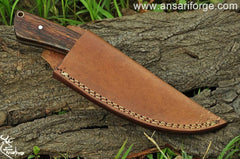 Handmade Forged Hunting Knife featuring a high carbon steel blade and a rosewood handle, displayed on a rustic wooden background.