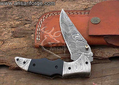 Handmade Damascus folding knife with a twist pattern, buffalo horn handle, and a leather sheath.