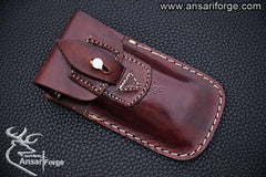 Folding Damascus pocket knife in handmade leather sheath.