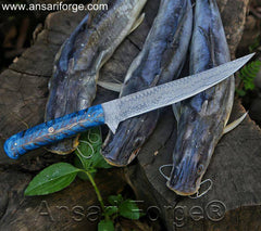 Fillet Fishing Knife Handmade Damascus Steel Knife With Flexible Blade laying on cat fish