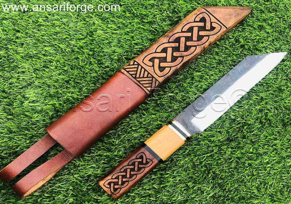 Beagnoth Viking Seax Knife on grass, showing the full knife and sheath.