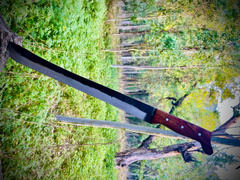 Hand-forged 1095 high carbon steel machete knife with rosewood handle and leather sheath.