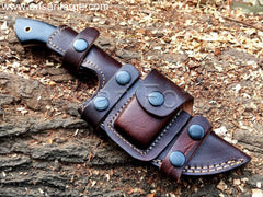 Custom Damascus Tracker Knife with hand-forged blade, black Micarta handle, and brown leather sheath.