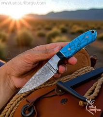 Ansari Forge Handmade Cowboy Knife with raindrop Damascus steel blade and leather sheath.