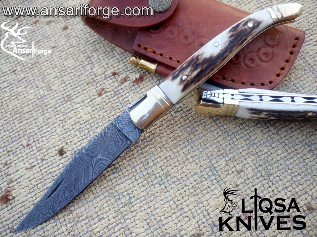 Laguiole knife open, showcasing Damascus steel blade patterns.