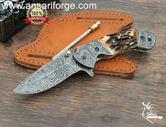 Handmade Damascus Steel Folding Knife with Stag Antler Handle and pure brass frame.
