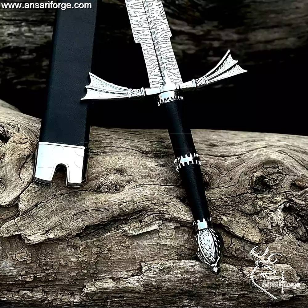 Detail of the Zinc Alloy pommel with beautiful art work and the wings-type hand guard on the Dark Sister Medieval sword.