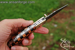 Ergonomic wooden handle of the Ansari Forge folding pocket knife with stainless steel file work.