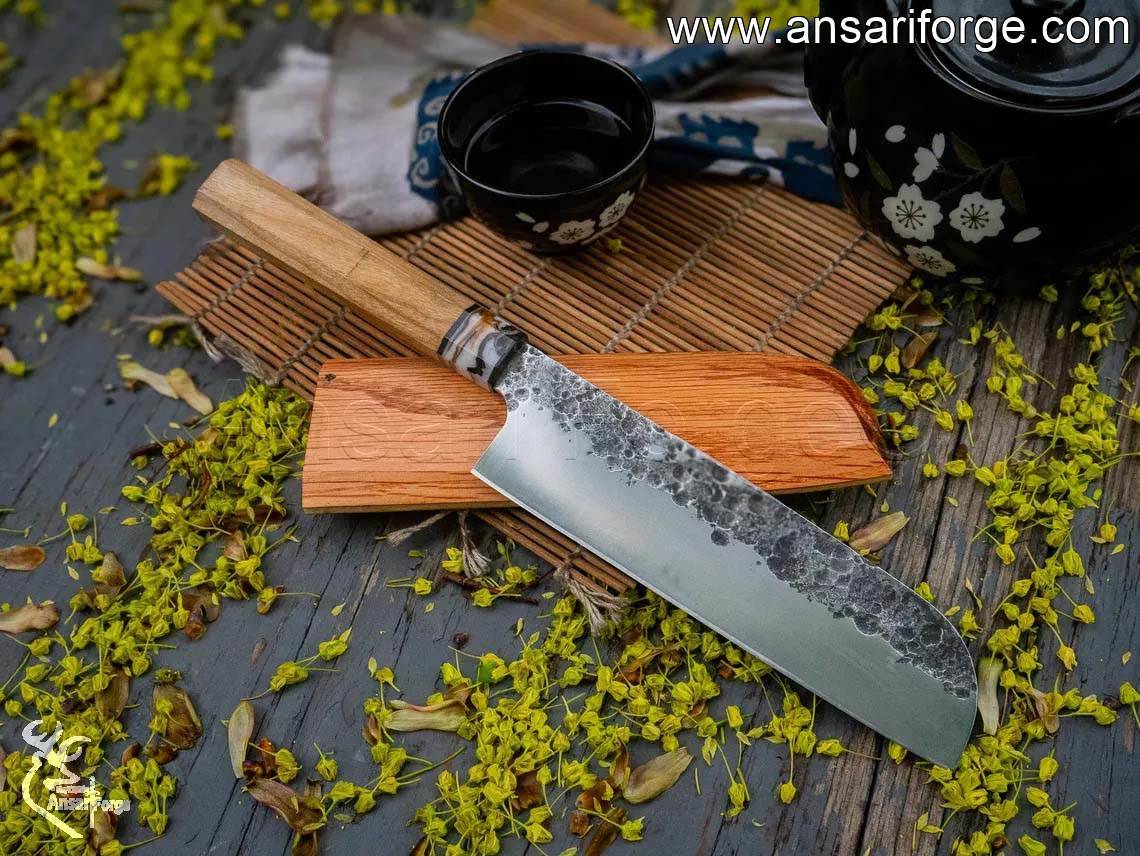 Ansari Forge hand-forged 7-inch Santoku knife with olive wood handle and oak wood sleeve.
