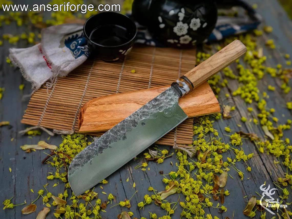 Close-up of a Santoku knife blade, showcasing the hand-forged 80CRV2 steel and 60-63 HRC hardness.
