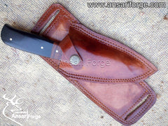 Black Eagle X hunting knife displayed with its hand-stitched horizontal leather sheath made from genuine cowhide leather.
