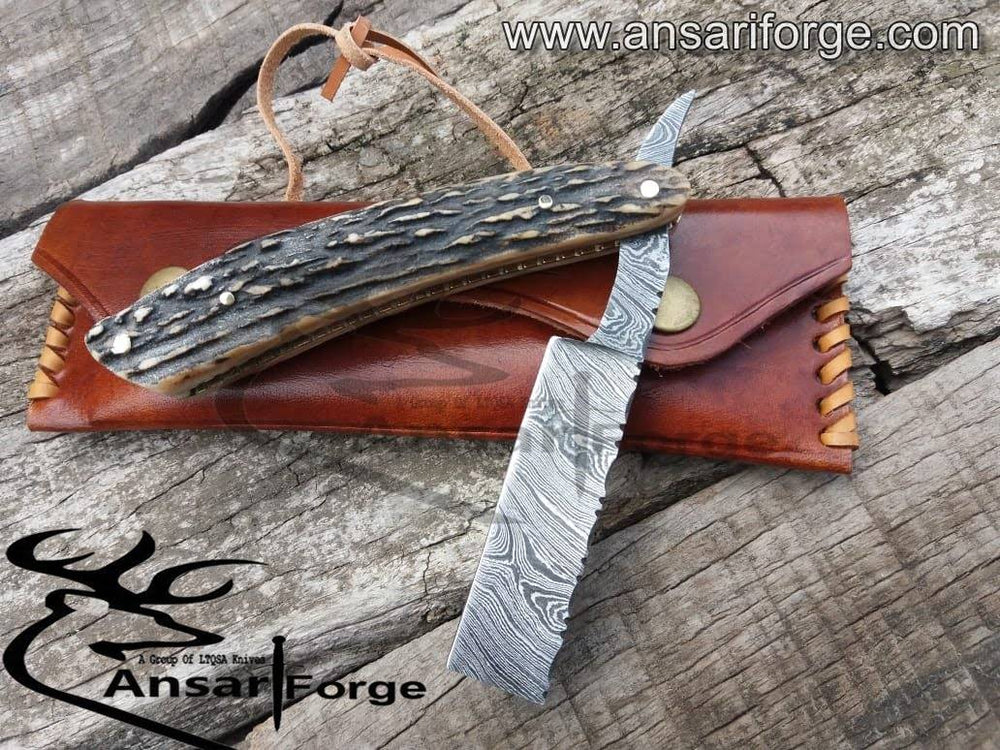 Handmade Damascus steel straight razor with antler handle and brass frame.