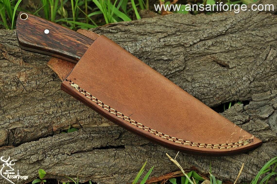 Handmade Forged Hunting Knife featuring a high carbon steel blade and a rosewood handle, displayed on a rustic wooden background.