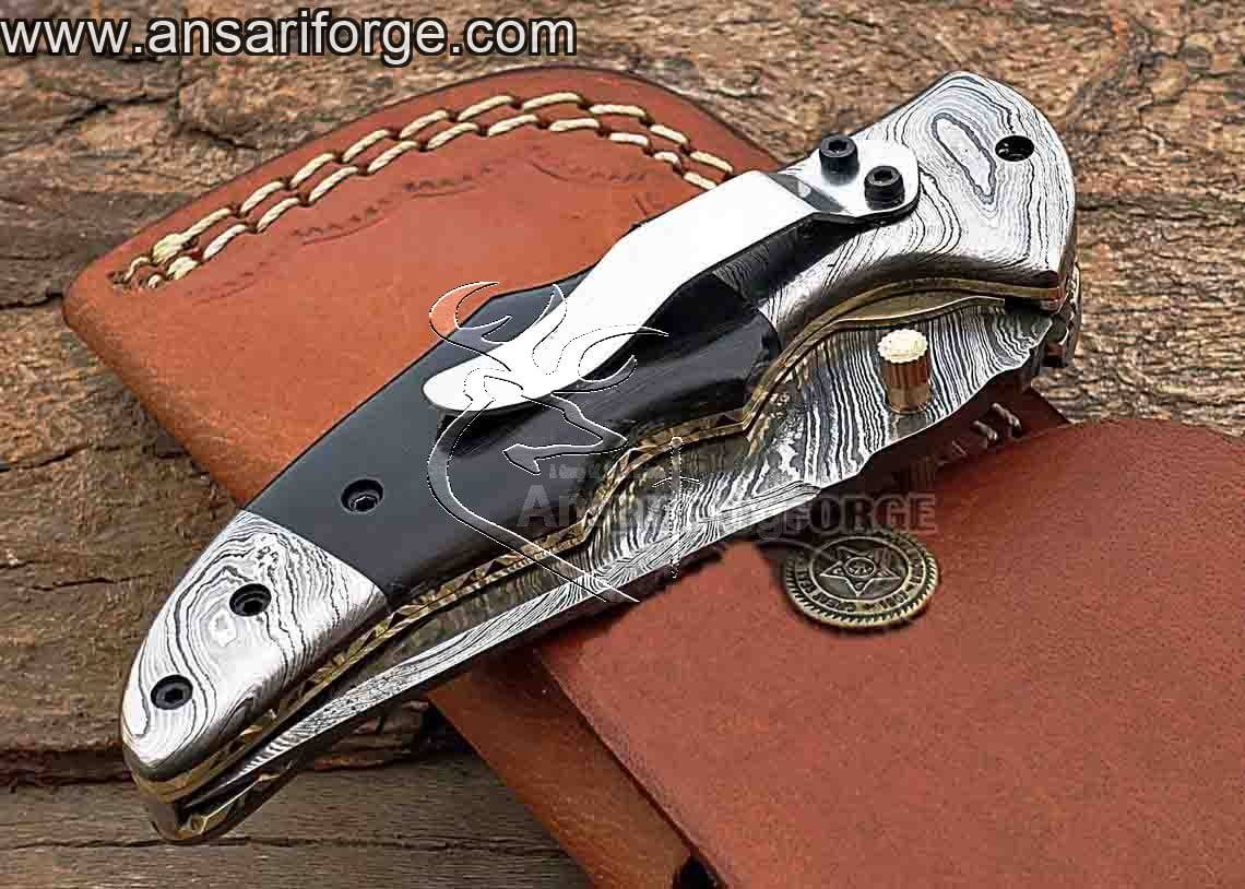 A high-quality, handmade Damascus folding knife with a sleek design and a comfortable grip.
