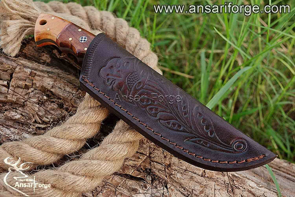 Damascus hunting knife with leather sheath.