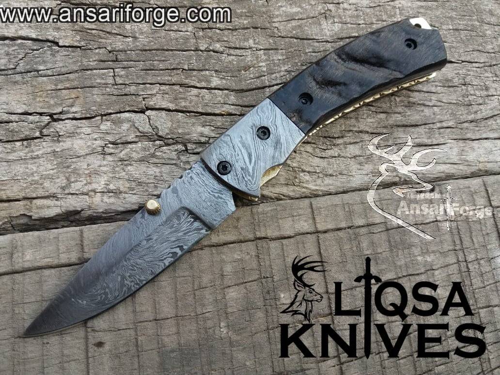 Hand-forged Damascus folding knife with Fire pattern, sheep horn handle, and leather sheath.