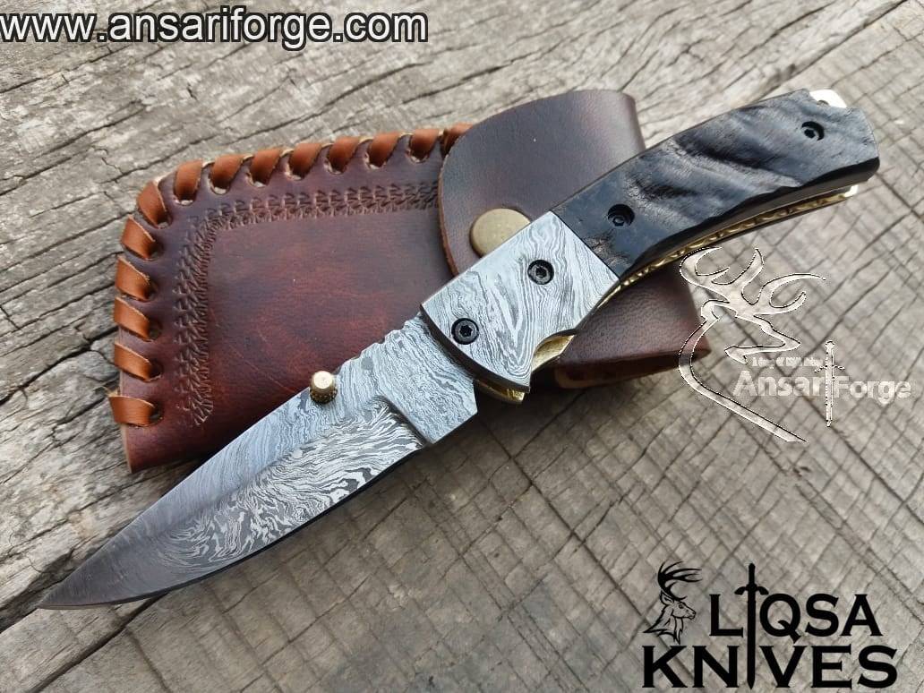 Best Damascus folding knife displayed with its genuine cowhide leather sheath. On sale now.