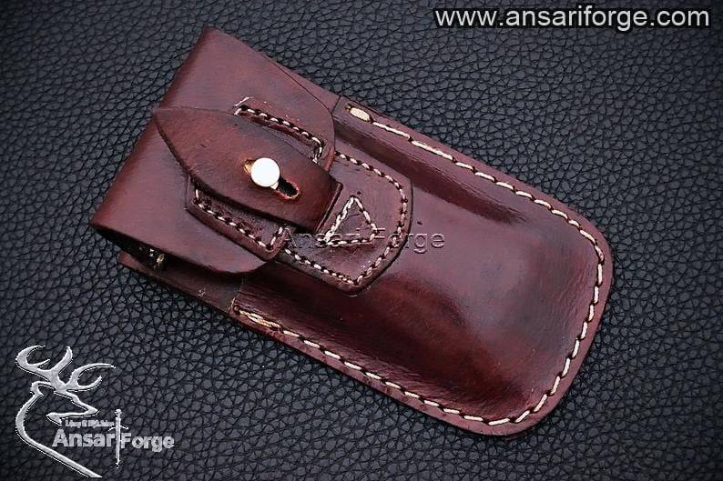 Folding Damascus pocket knife in handmade leather sheath.