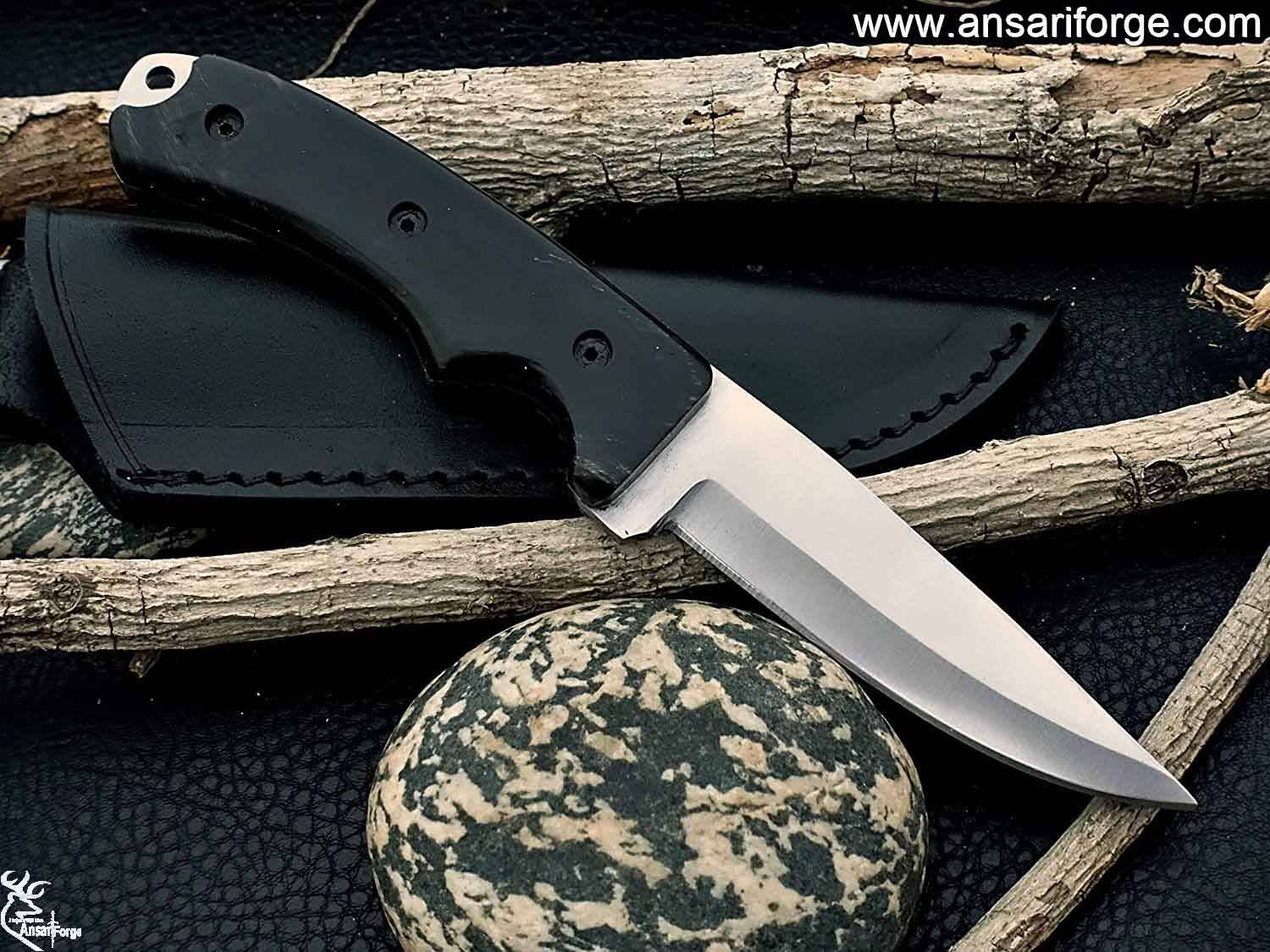 Full Tang Hunting Knife by Ansari Forge featuring a hand-forged D2 tool steel blade with a drop point design, buffalo horn handle, and black leather sheath.