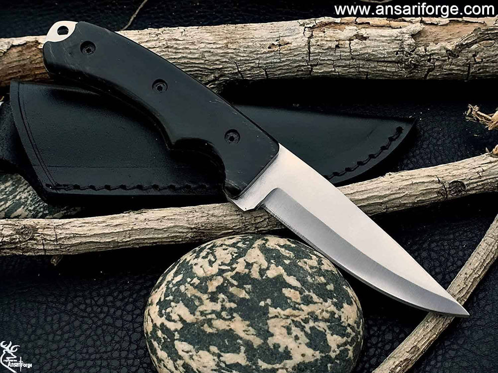 Full Tang Hunting Knife by Ansari Forge featuring a hand-forged D2 tool steel blade with a drop point design, buffalo horn handle, and black leather sheath.
