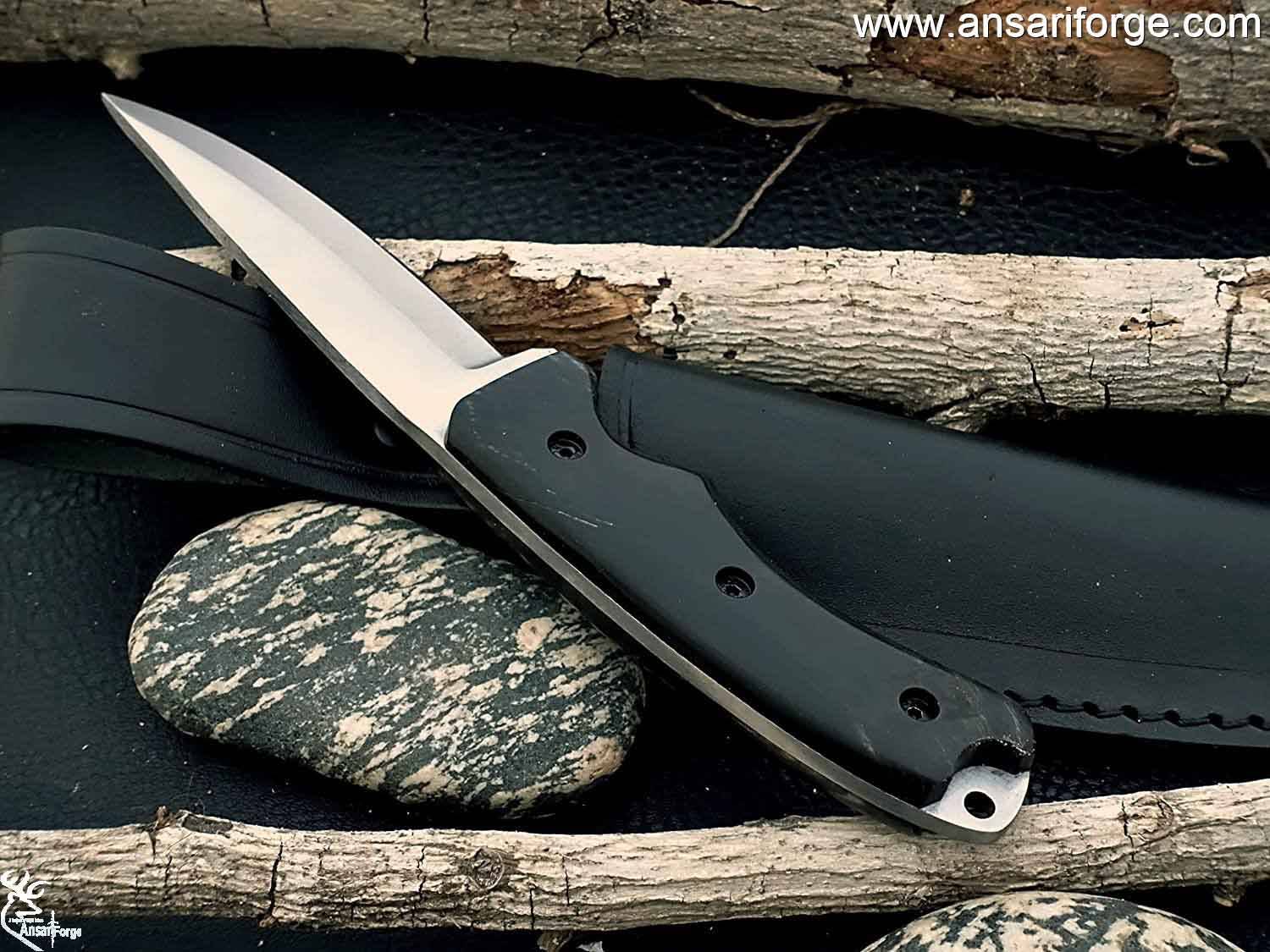 Full Tang Hunting Knife by Ansari Forge featuring a hand-forged D2 tool steel blade with a drop point design, buffalo horn handle, and black leather sheath.