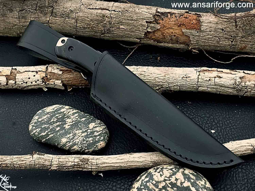 Full Tang Hunting Knife by Ansari Forge featuring a hand-forged D2 tool steel blade with a drop point design, buffalo horn handle, and black leather sheath.