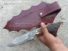 Stag Antler handle knife with black D2 knapped steel blade in brown leather sheath.