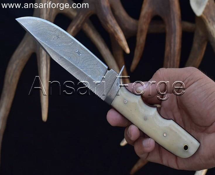 Damascus steel hunting knife, camel bone handle, leather sheath.