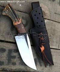 Handcrafted stag handle knife with a high-carbon steel blade and leather sheath.