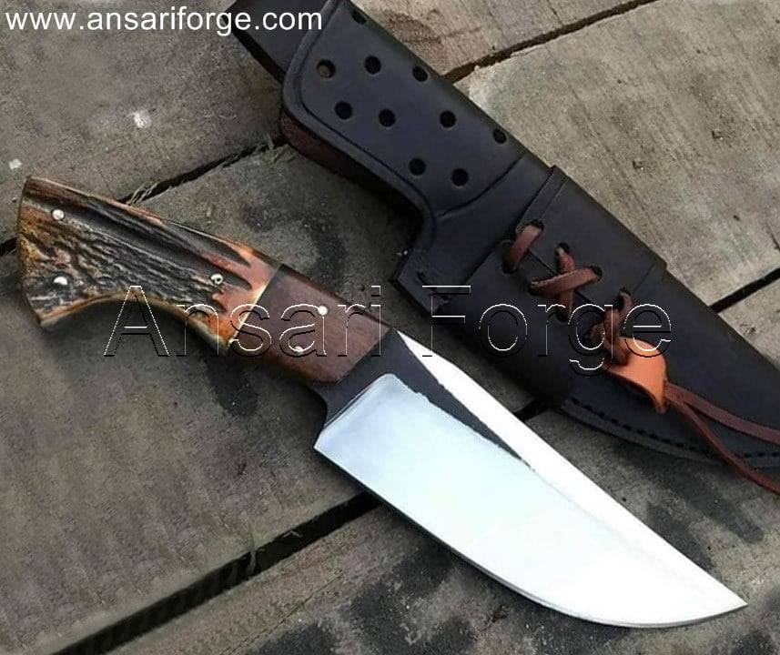 Handcrafted stag handle knife with a high-carbon steel blade and leather sheath.