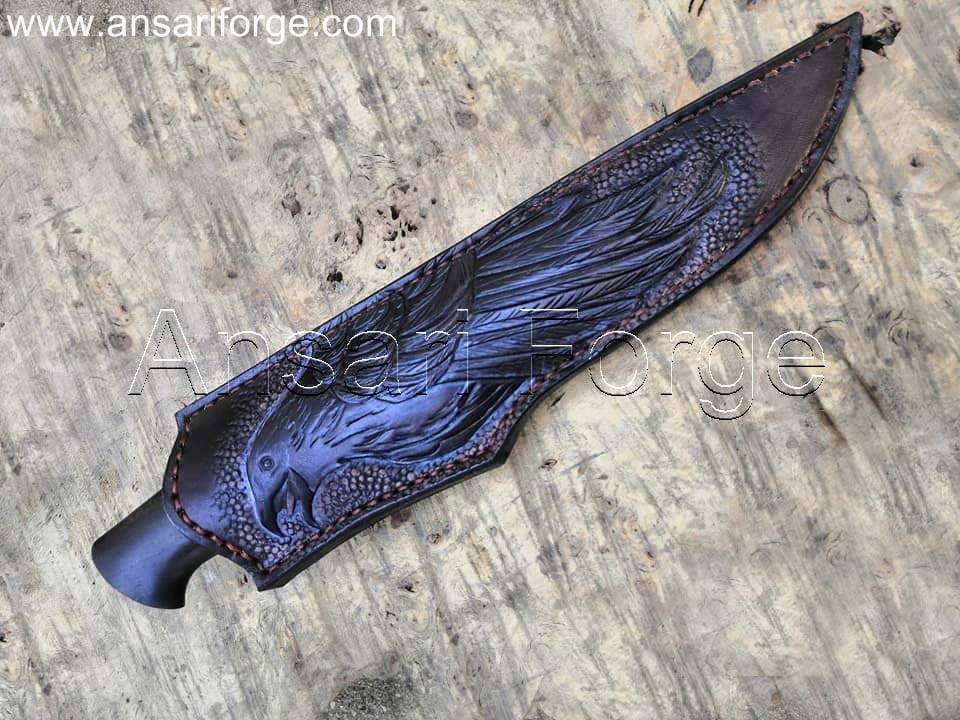 Munin Viking Knife by Ansari Forge. Damascus steel blade (1095 & 15n20) with a 60 HRC hardness, ebony wood handle, copper spacer, and stainless steel guard. Includes cowhide leather sheath with raven engraving. Overall length: 11.0 inches.