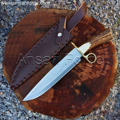 Tombstone Bowie Knife with a stag antler handle and brass ring guard resting on a wooden table