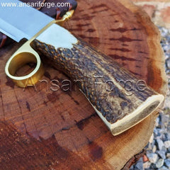 Detailed view of the Tombstone Bowie Knife's stag antler handle with brass ring guard.