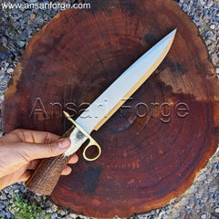 Person using the Tombstone Bowie Knife to cut wood in a forest environment.