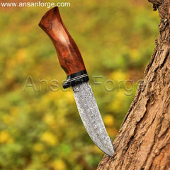 Damascus knife with rain drop pattern blade, rosewood handle, and cowhide leather sheath.