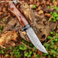 Damascus knife with rain drop pattern in blade, rosewood handle, and cowhide leather sheath.