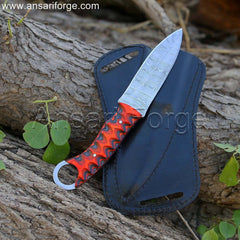 EDC fixed blade knife comfortably held in hand, highlighting the ergonomic design of the Pakkawood handle with finger hole.