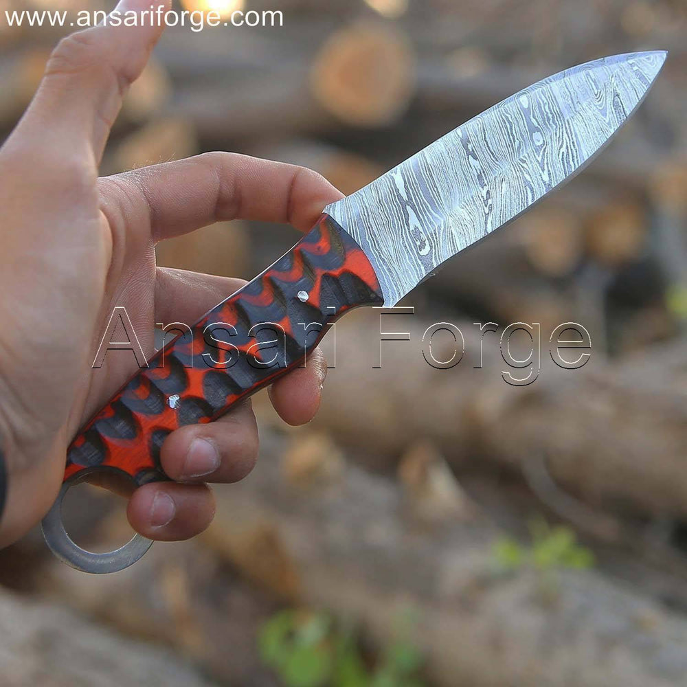 Close-up view of the EDC fixed blade knife's Damascus steel blade, showcasing the intricate twist pattern.