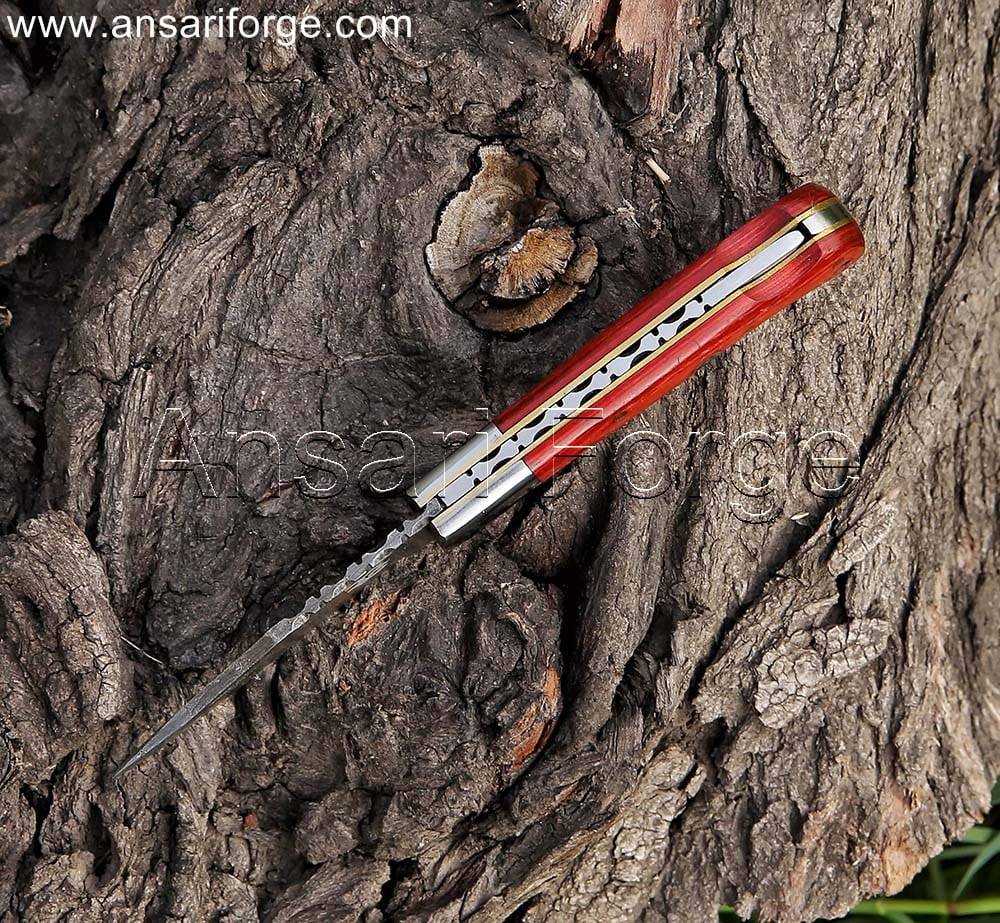 Damascus pocket knife with red pakkawood handle and leather sheath.