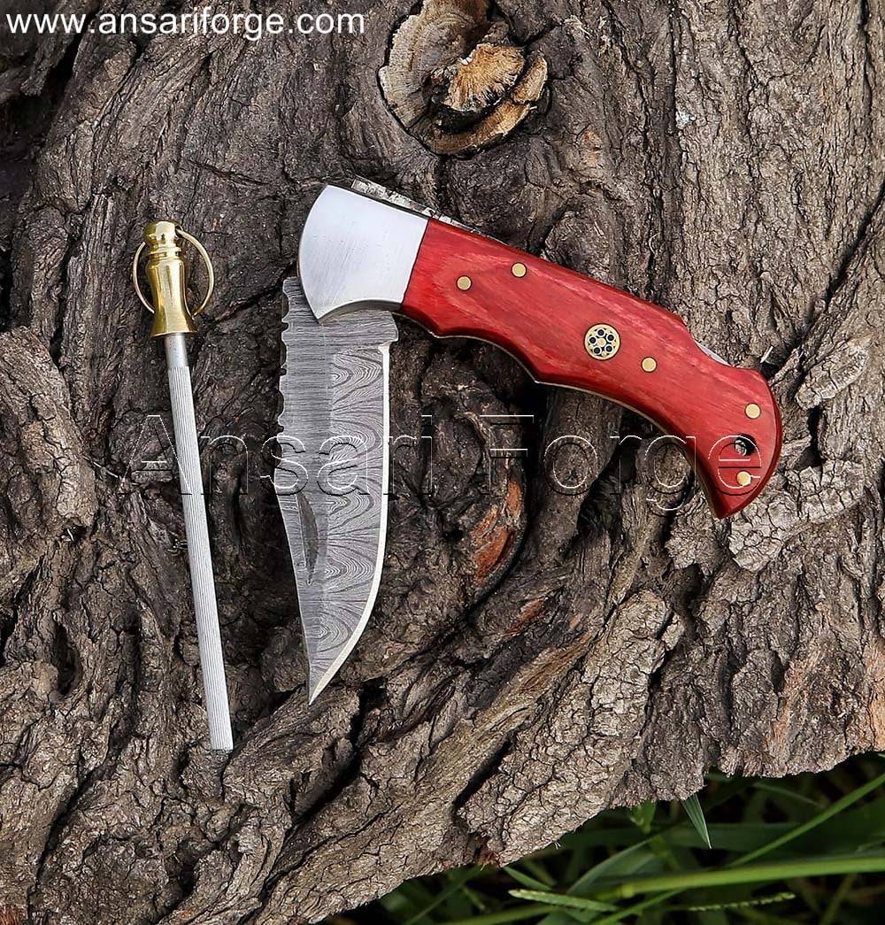 Hand-forged Damascus pocket knife with sharpener featuring a twist pattern blade, red pakkawood handle, and a genuine cowhide leather sheath.