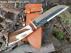 Bowie Knife with hand-forged 5160 high carbon steel blade, clip point, stag antler handle, brass guard, and cowhide leather sheath