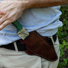 Best Damascus Skinning Knife with sheath - Depicts the knife resting securely in the horizontal cowhide leather sheath.