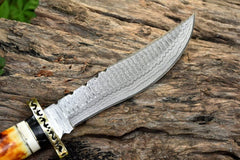 Close-up view of the hand-forged Damascus steel blade showcasing intricate patterns and a sharp clip point.