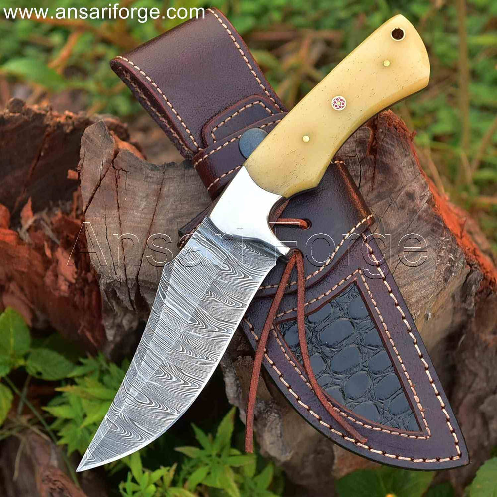 Handmade Damascus Hunting Knife with twist pattern Damascus steel blade, camel bone handle, and cowhide leather sheath.
