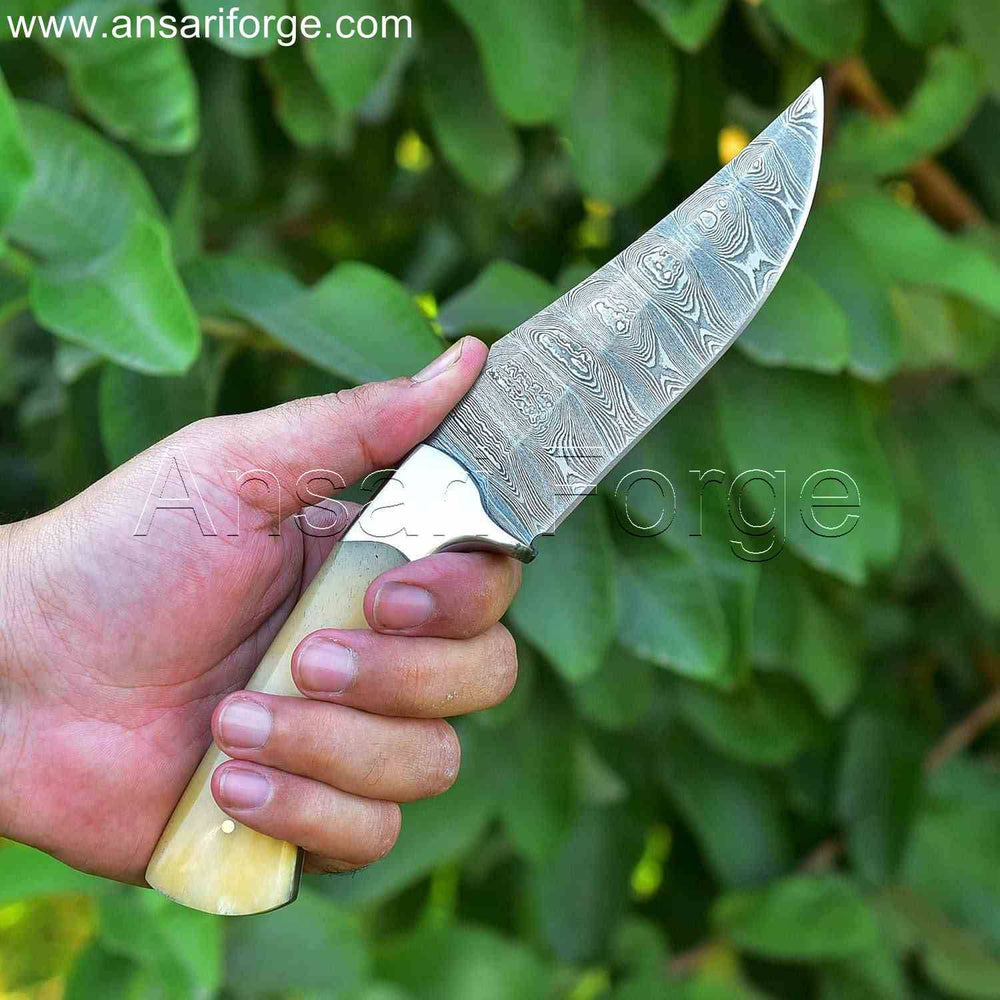 Handmade Damascus Hunting Knife with twist pattern blade, camel bone handle, and leather sheath.