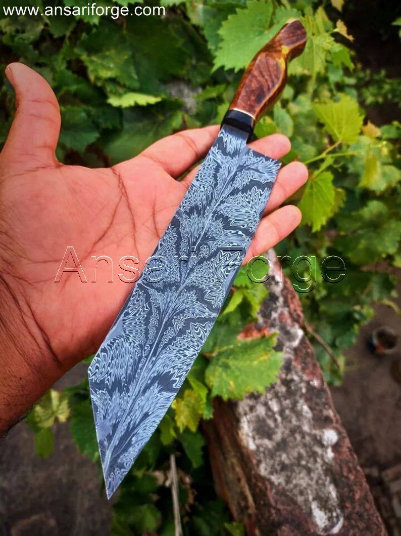 Mosaic Damascus Chef Knife in hand, highlighting the comfortable rosewood handle and buffalo horn bolsters.