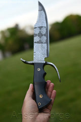 A son holding mosaic Damascus Bowie knife surprising his father on Father' day