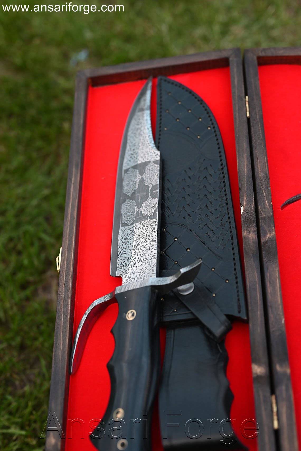 Hand-forged Mosaic Damascus Bowie Knife with buffalo horn handle, Damascus steel guard, and black cowhide leather sheath with scrimshaw artwork, displayed in a custom wood gift box with laser engraving, overall length 15 inches, blade length 10 inches